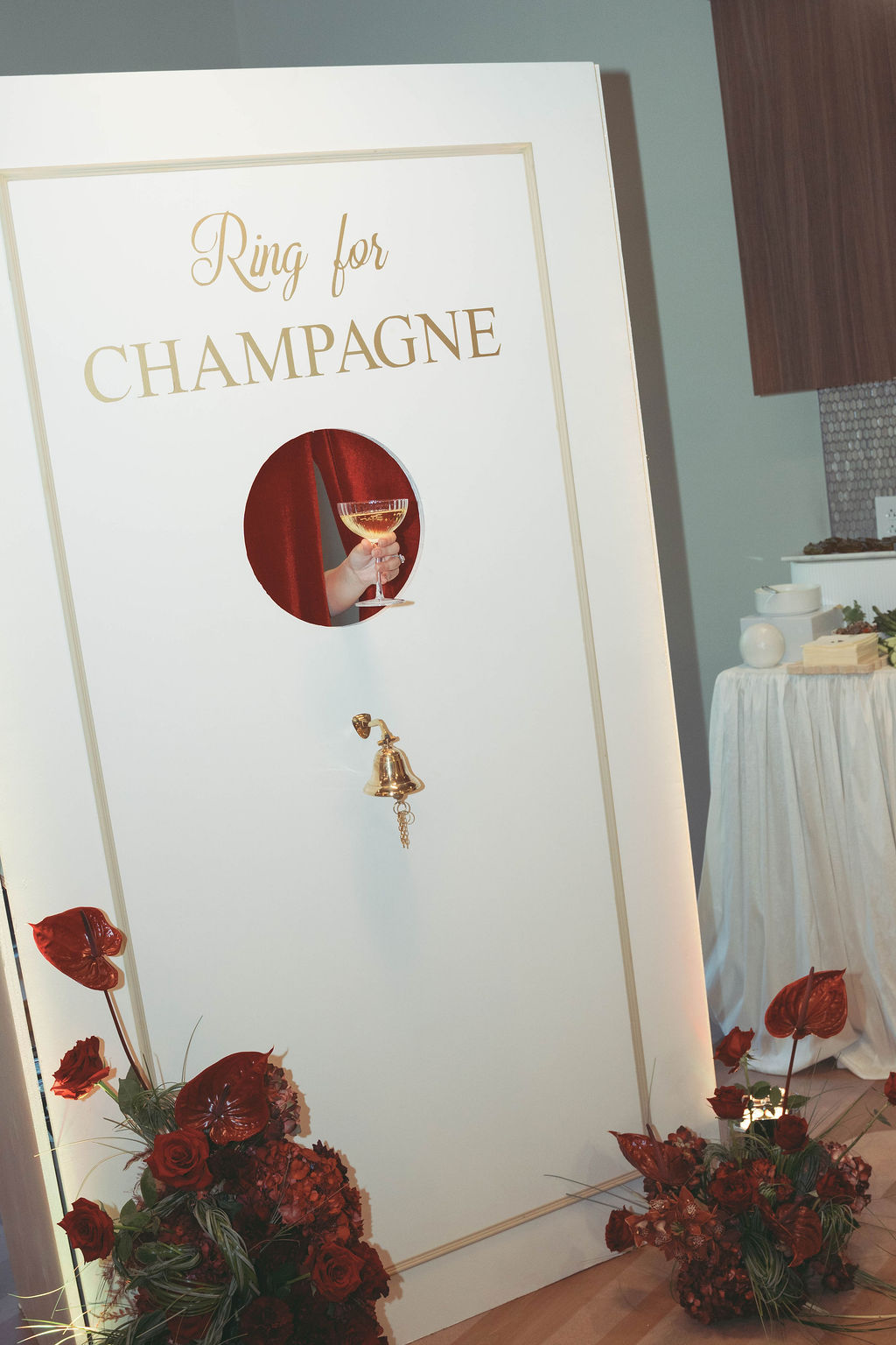 Custom “Ring for Champagne” installation featuring luxury floral design and interactive guest experiences at a Virginia Beach corporate grand opening event planned and produced by Lustre Theory.