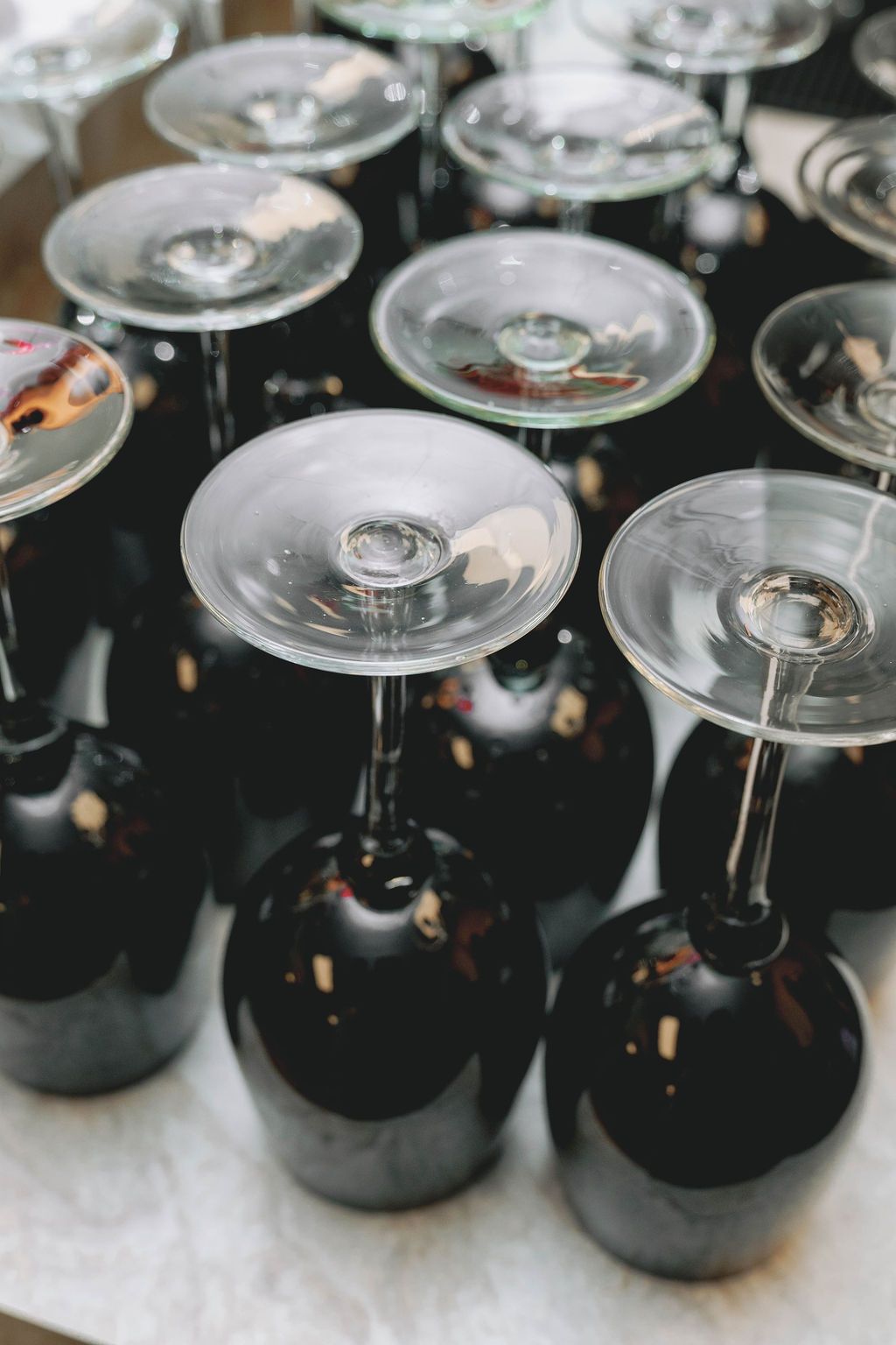 Black stemmed coupe glasses styled for cocktail service at a Virginia Beach corporate grand opening event designed and produced by Lustre Theory.
