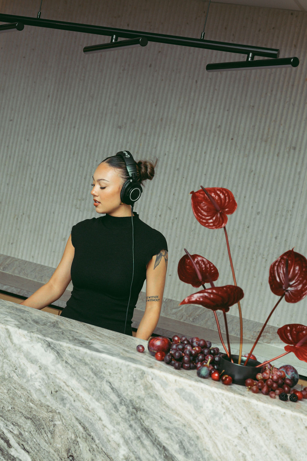 Live DJ entertainment with custom floral installations and branded event styling at a Virginia Beach corporate grand opening designed and produced by Lustre Theory.