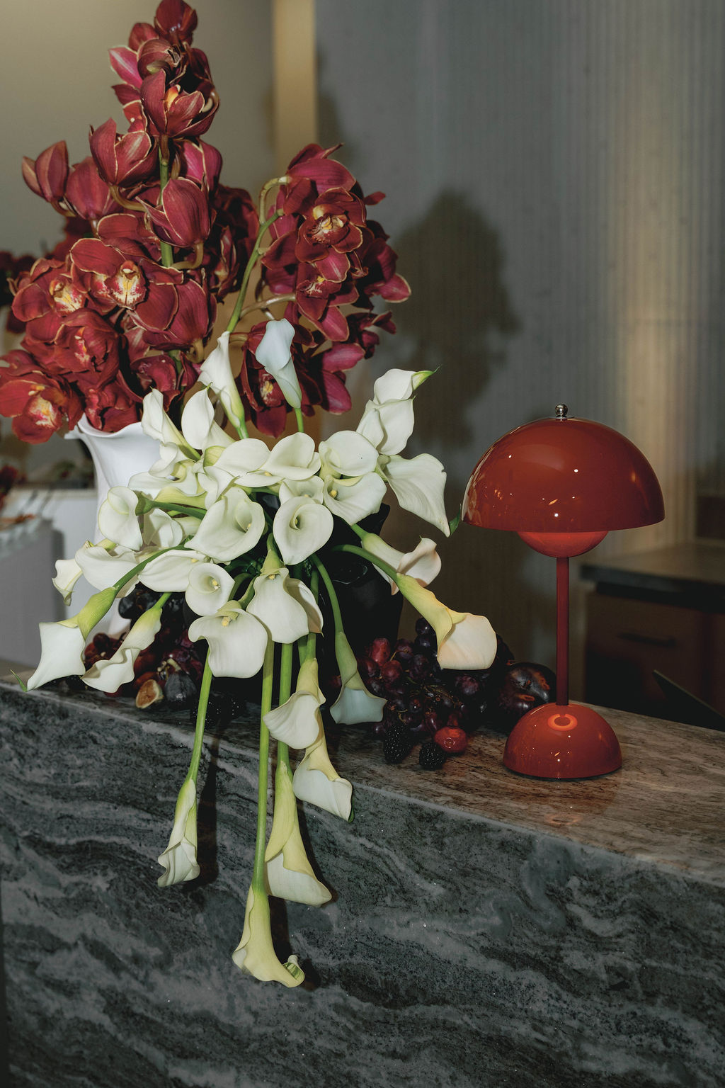 Custom floral installation featuring burgundy orchids, white calla lilies, and curated styling details for a Virginia Beach corporate grand opening event designed by Lustre Theory.