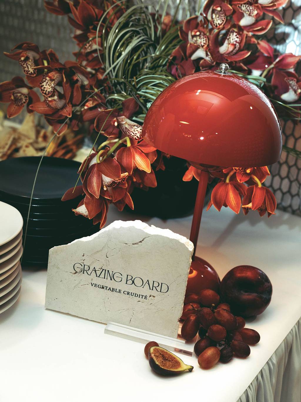 Custom grazing table display with floral design, specialty signage, and curated food presentation for a Virginia Beach corporate grand opening event planned and designed by Lustre Theory.