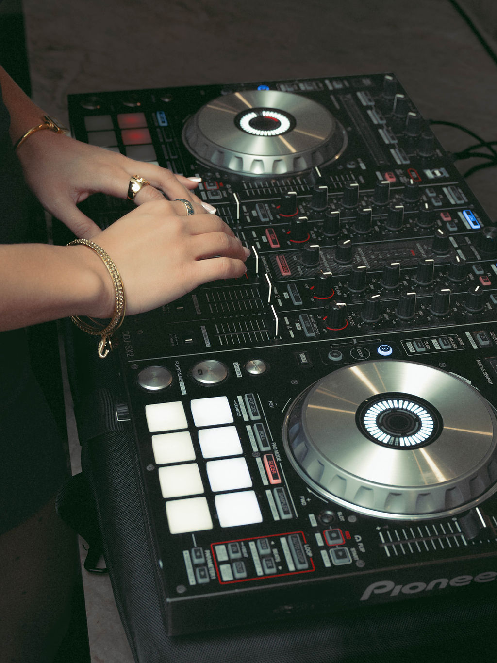 Professional DJ mixing music during a Virginia Beach corporate grand opening event, creating an elevated guest experience through live entertainment and event production by Lustre Theory.