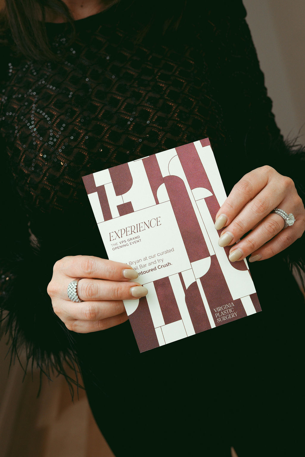Guest holding a custom experience card created for a Virginia Beach corporate event, showcasing personalized event design, branded guest experiences, and interactive planning by Lustre Theory.