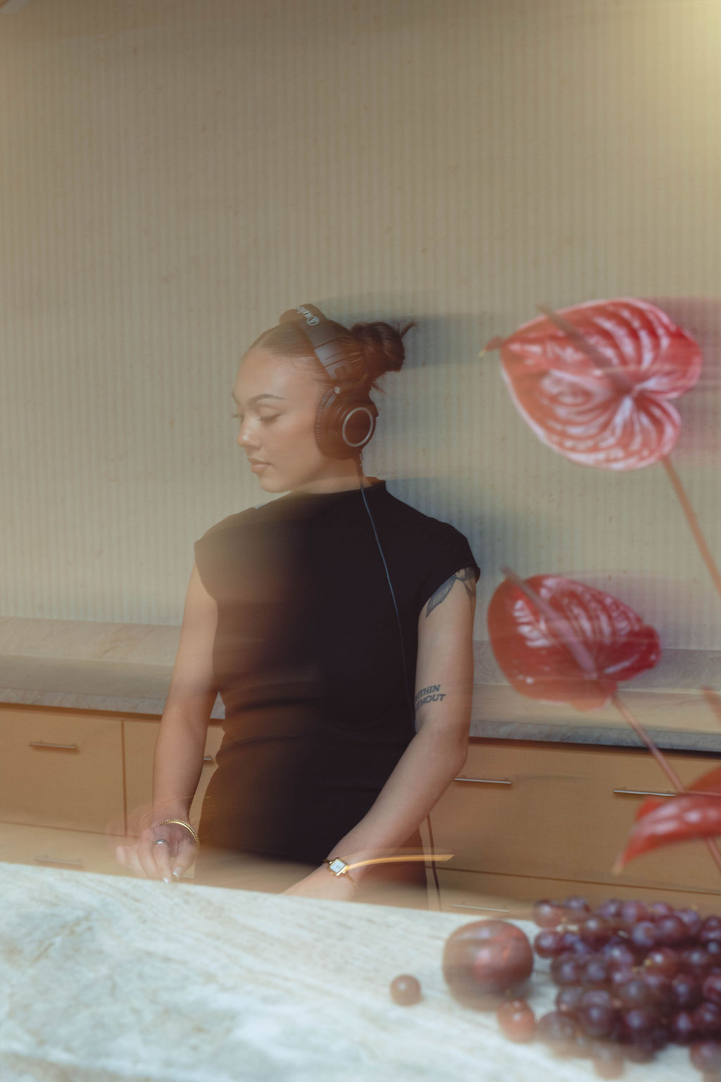 DJ performance styled within a custom-designed event environment featuring sculptural florals, branded décor, and immersive guest experiences at a Virginia Beach corporate grand opening event by Lustre Theory.