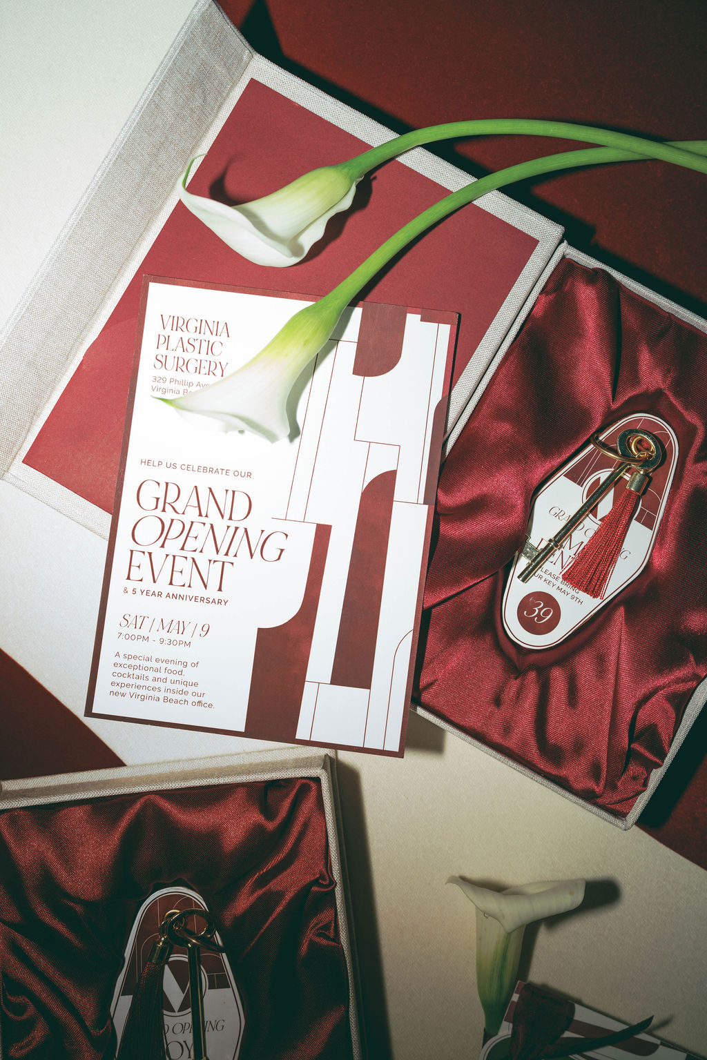 Custom invitation suite and key-themed guest experience details created for a Virginia Beach grand opening event, featuring branded stationery, silk-lined presentation boxes, and curated event design by Lustre Theory.